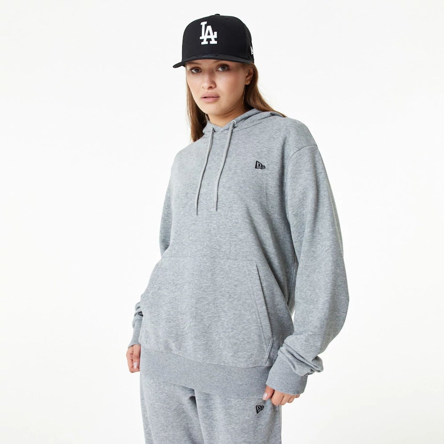 The Male model is wearing New Era Essential Grey Pullover Hoodie 3