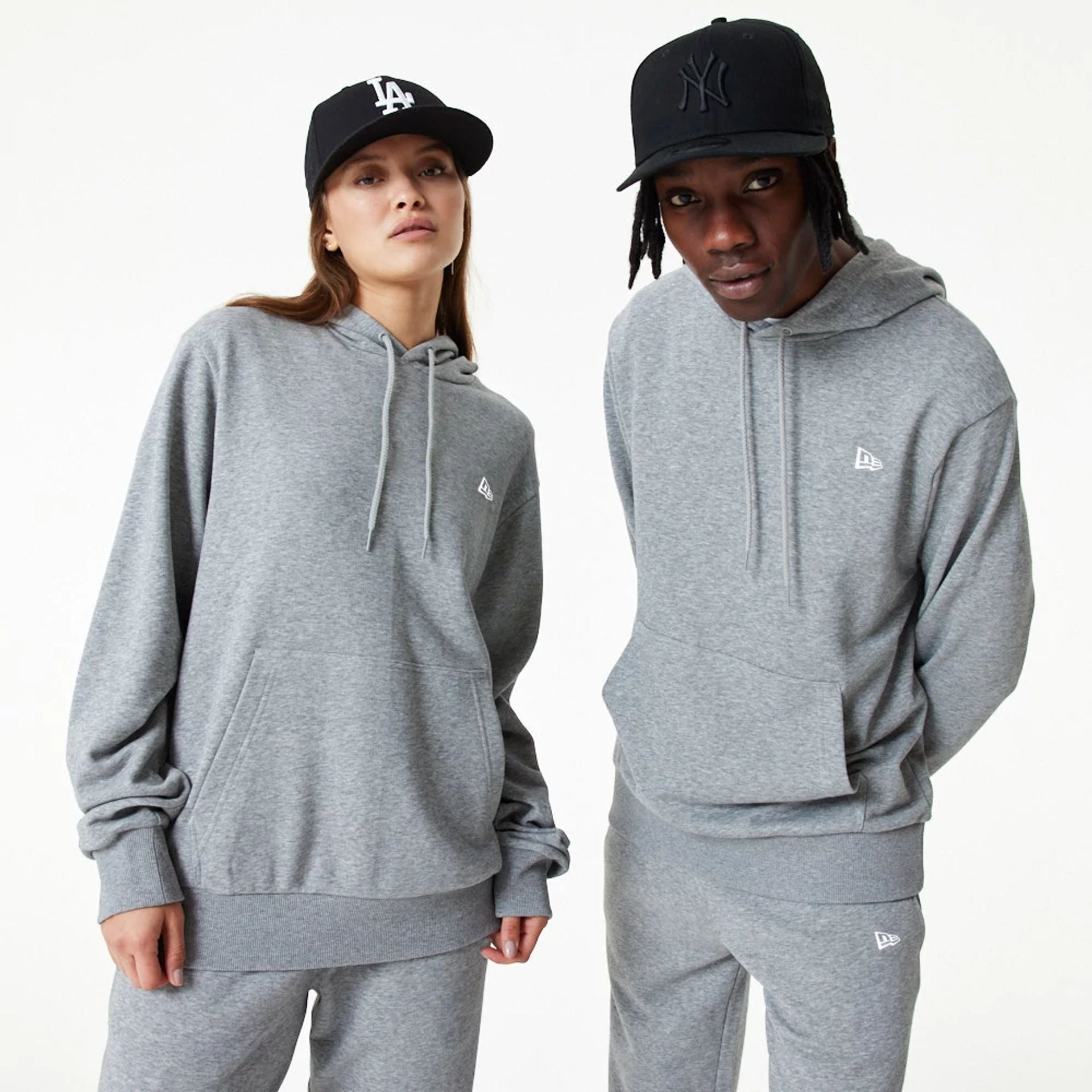 The Male model is wearing New Era Essential Grey Pullover Hoodie 1