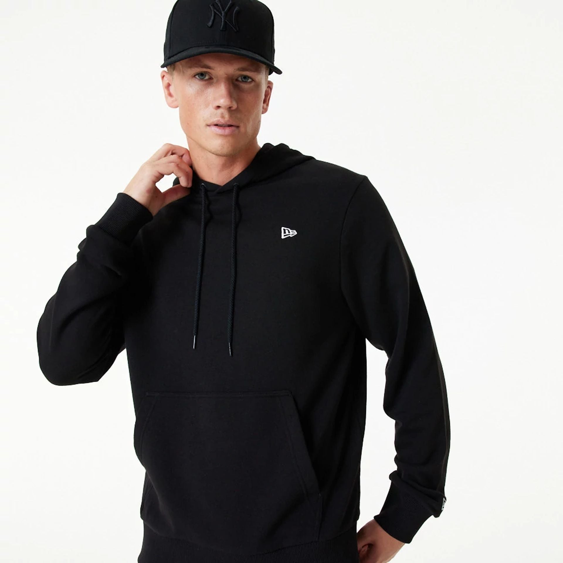 The Male model is wearing New Era Essential Black Pullover Hoodie 4