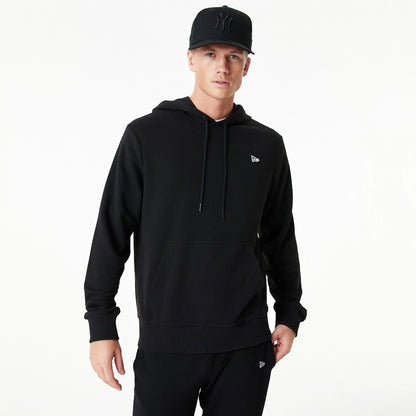 The Male model is wearing New Era Essential Black Pullover Hoodie 1