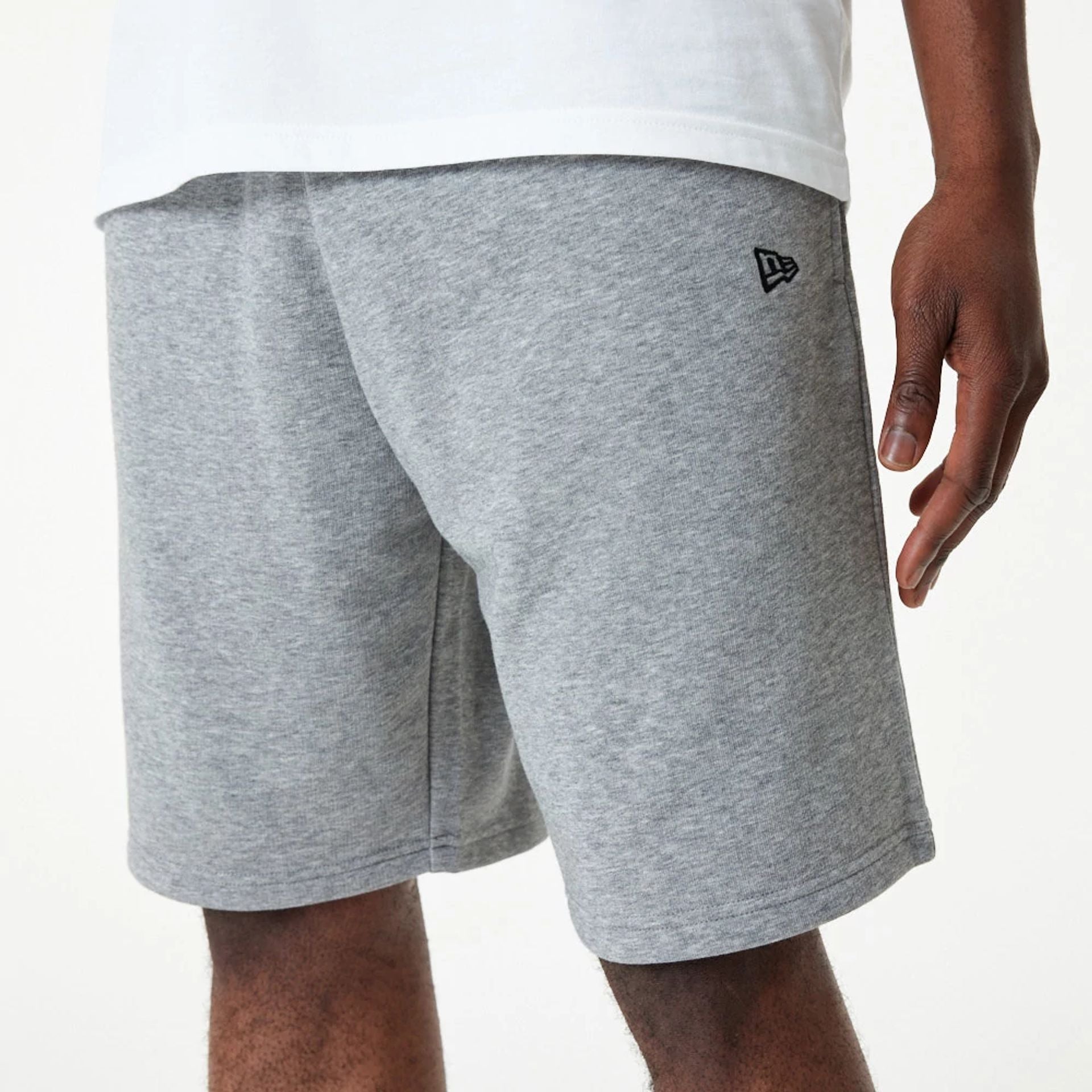 The Male model is wearing New Era Essential Grey Shorts 2