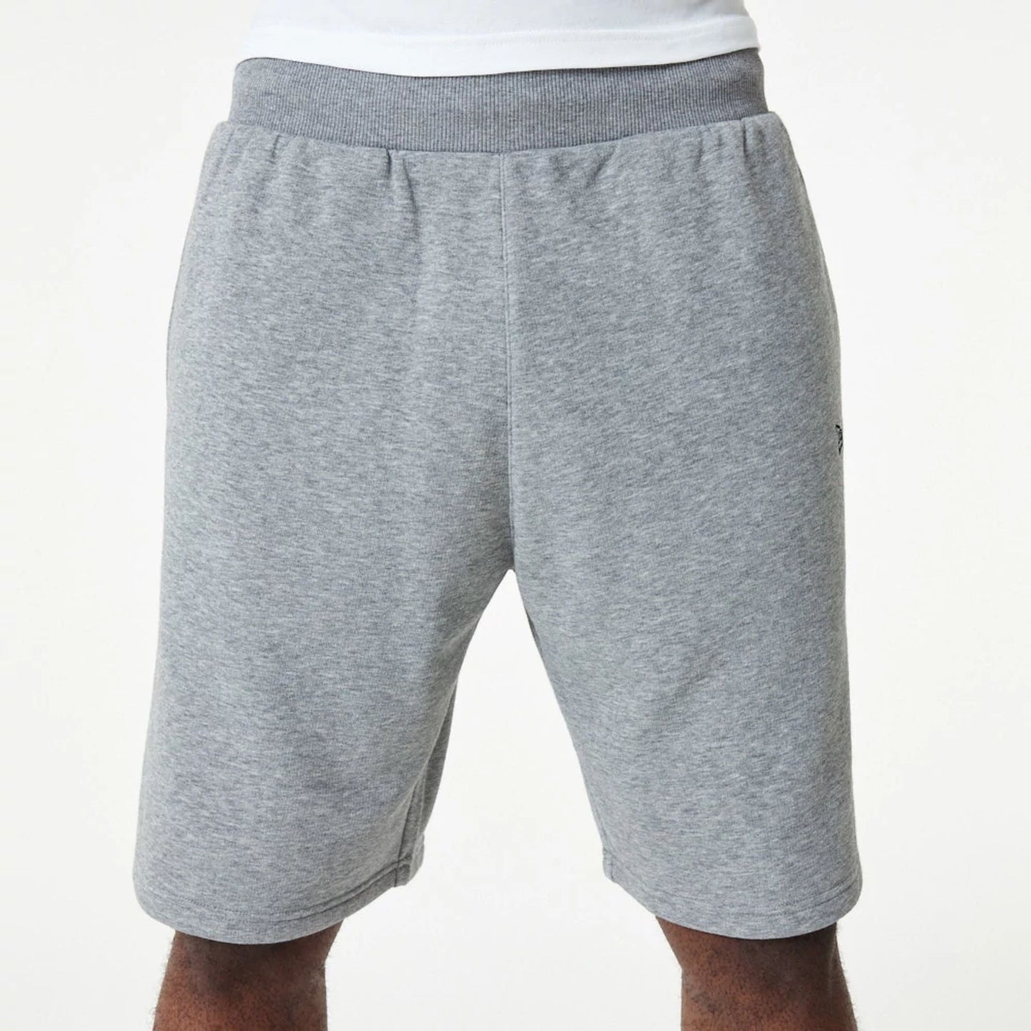 The Male model is wearing New Era Essential Grey Shorts 5