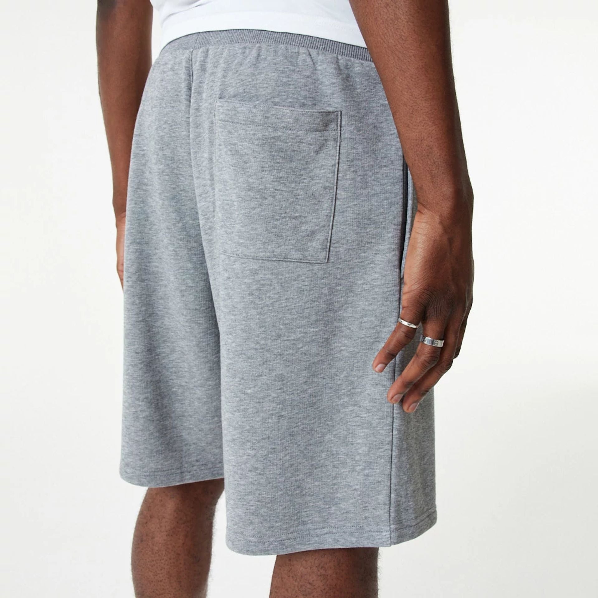 The Male model is wearing New Era Essential Grey Shorts 6