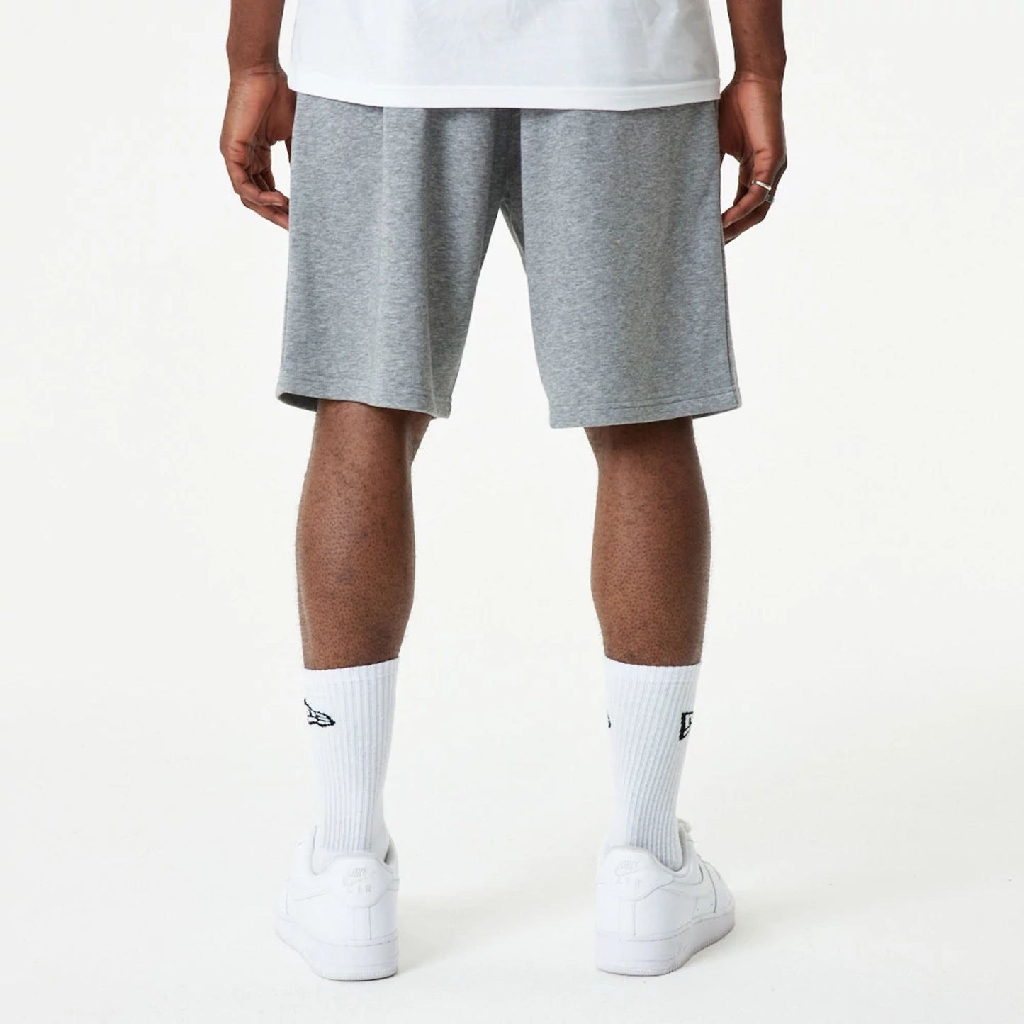 The Male model is wearing New Era Essential Grey Shorts 7