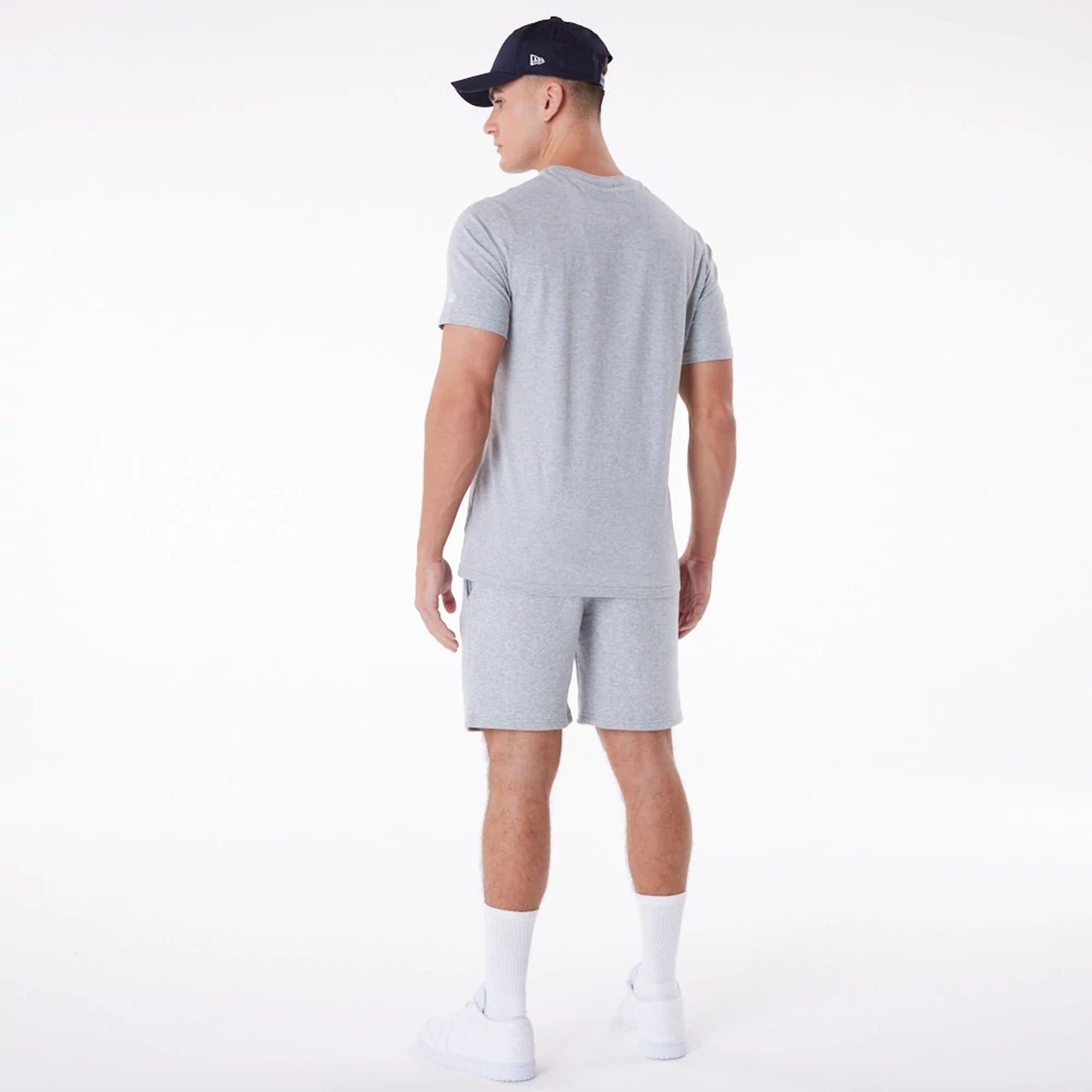 The Male model is wearing New Era Essential Grey Shorts 9