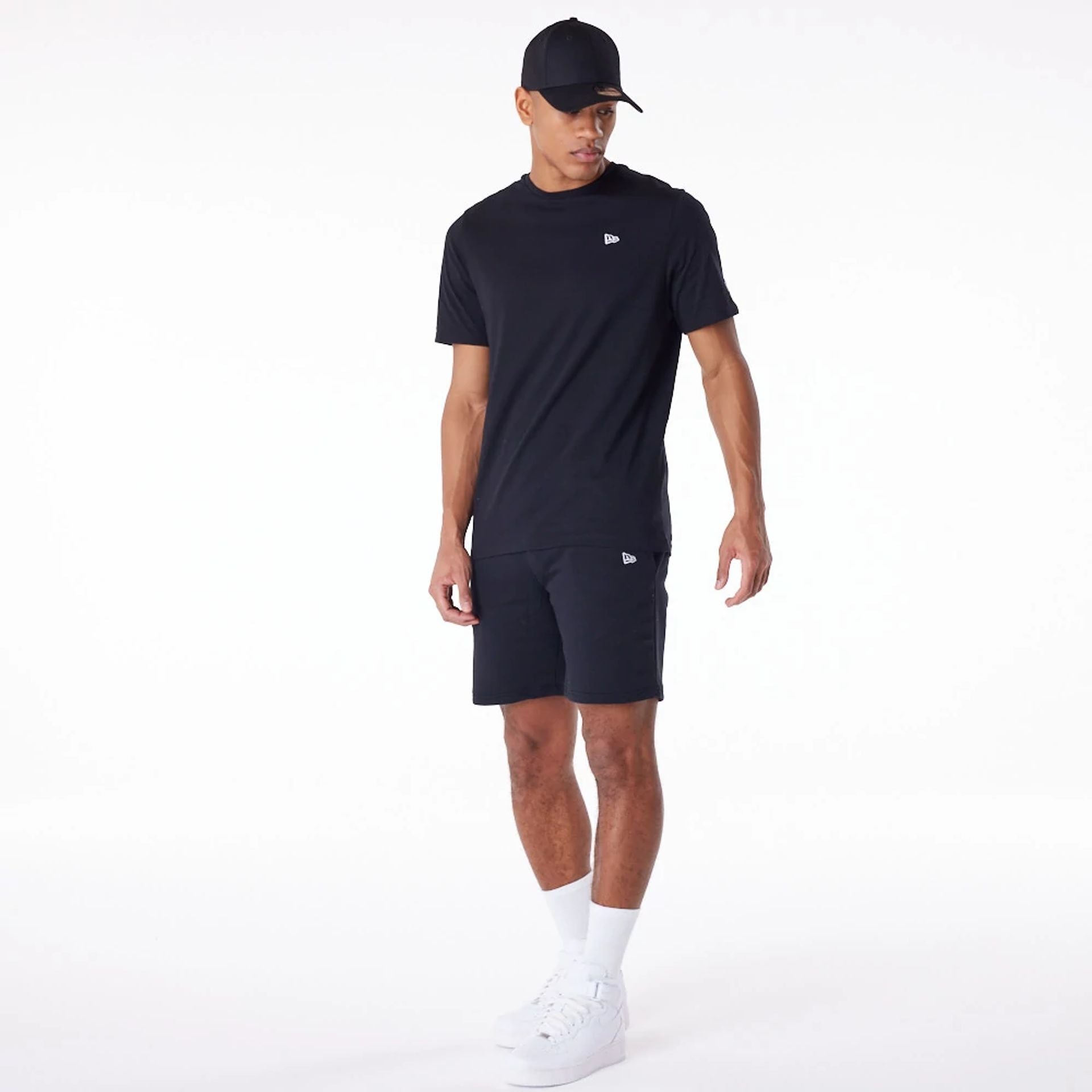 The Male model is wearing New Era Essential Black Shorts 8