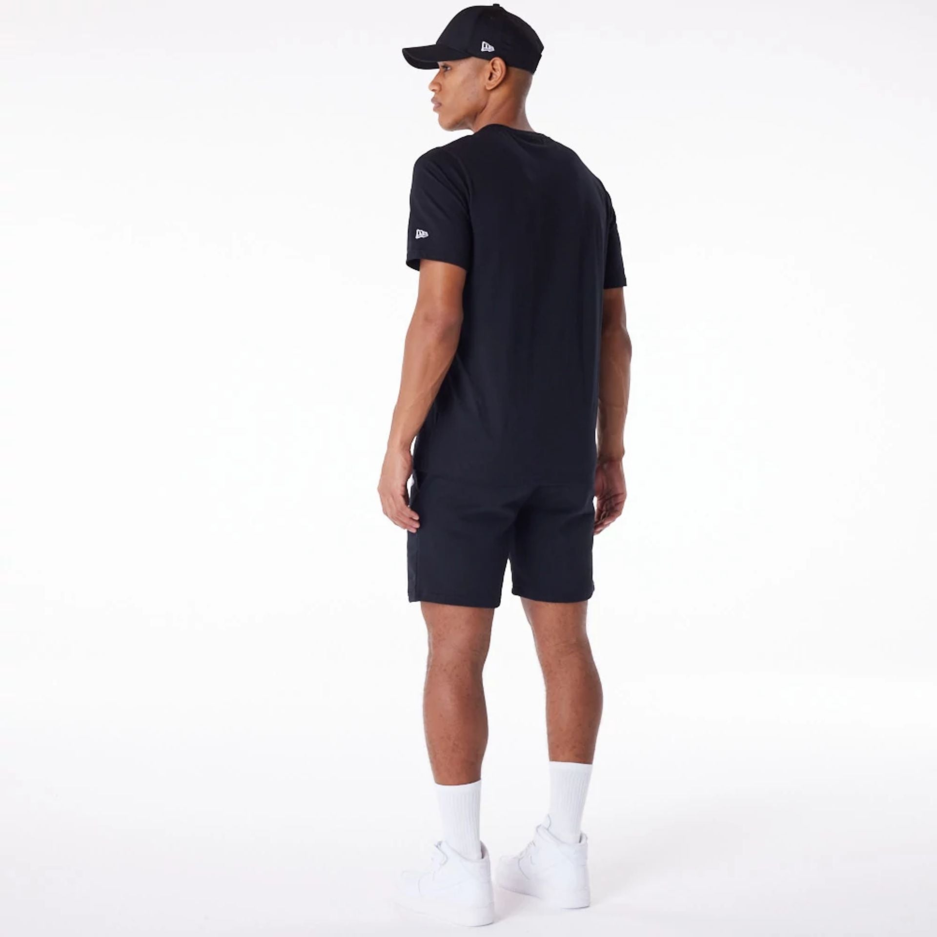 The Male model is wearing New Era Essential Black Shorts 9