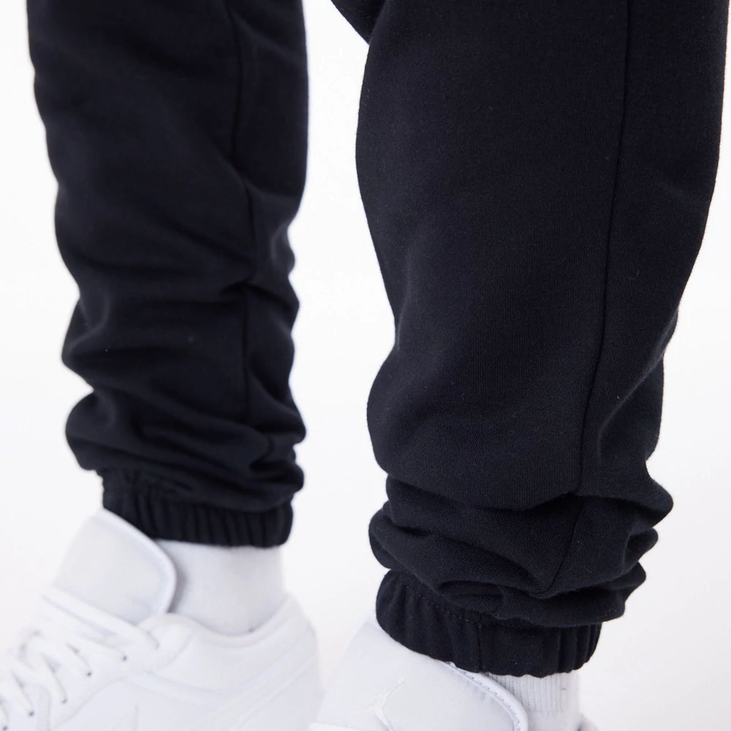 The Male model is wearing New Era Essential Black Joggers 4