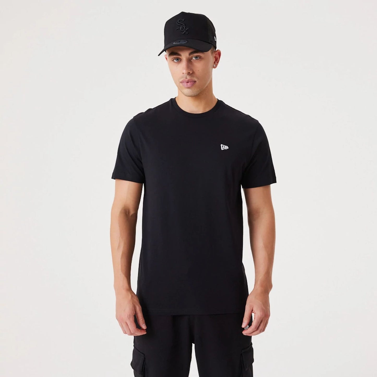 The Male model is wearing New Era Essential Black T-Shirt 2