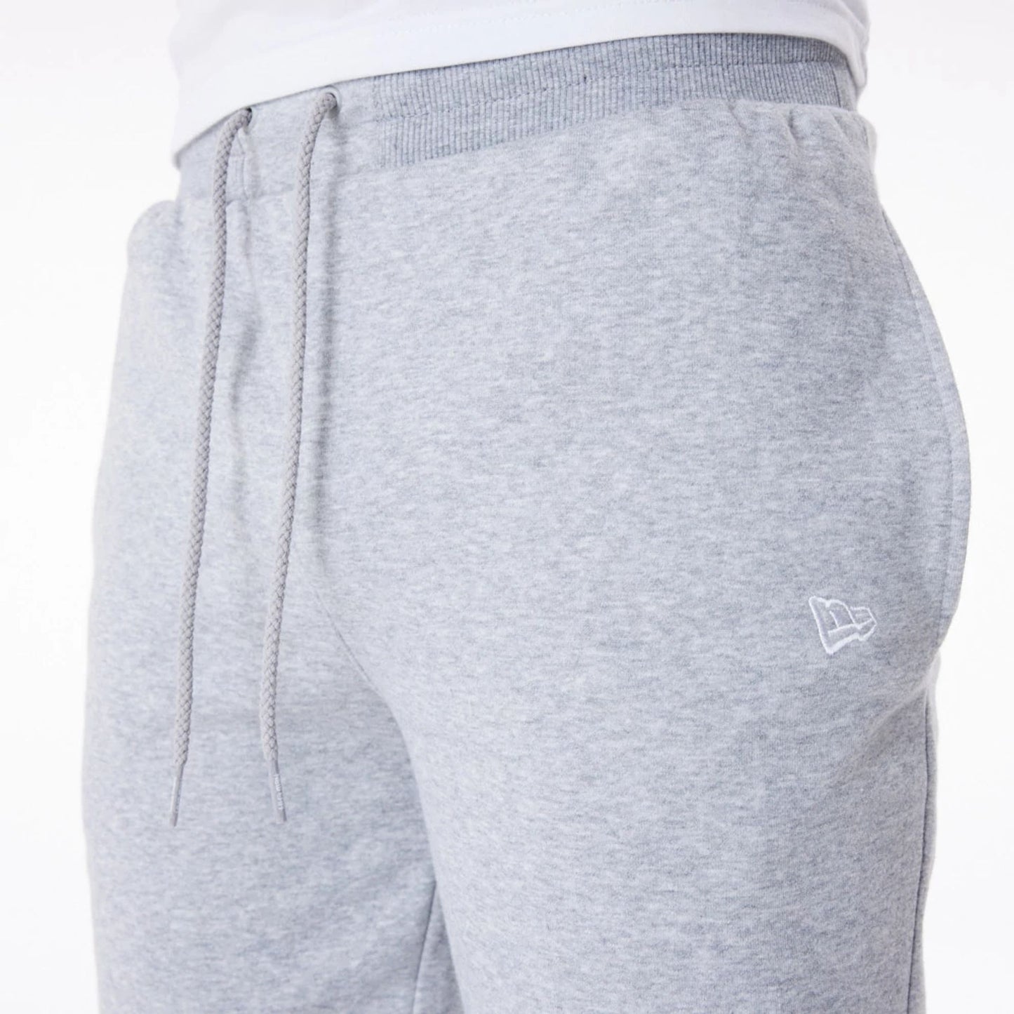 The Male model is wearing New Era Essential Grey Joggers 3