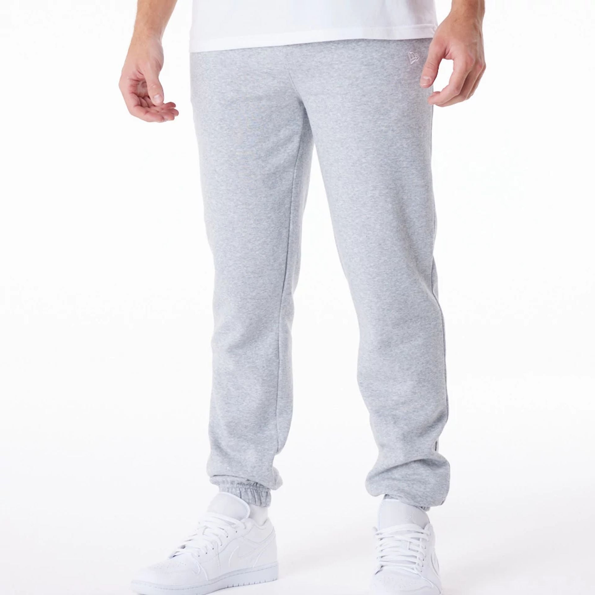 The Male model is wearing New Era Essential Grey Joggers 1