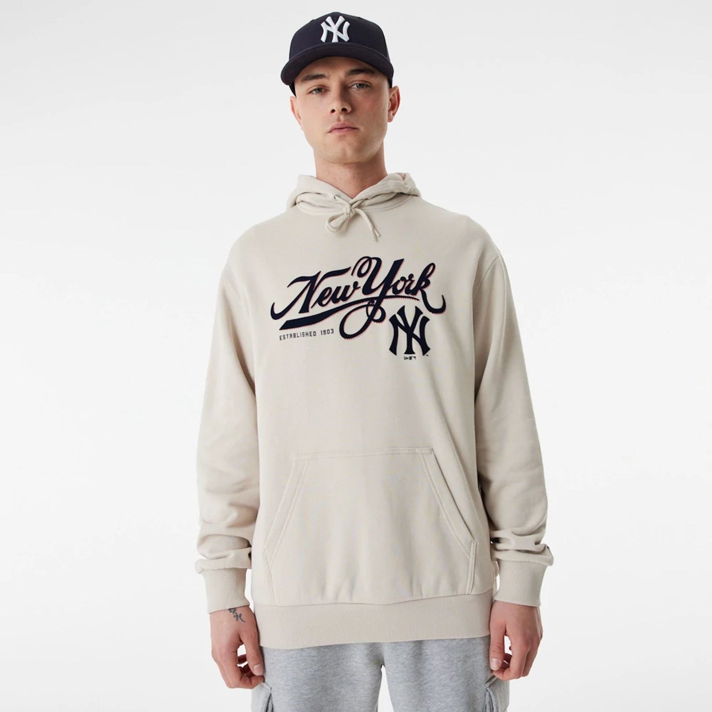 The Male model is wearing New York Yankees MLB Team Retro Graphic Light Beige Oversized Hoodie 1