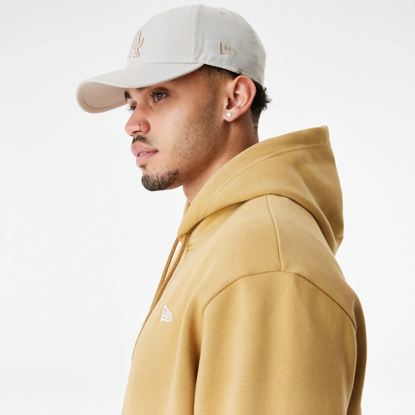 The Male model is wearing New Era Essentials Flag Brown Hoodie 6