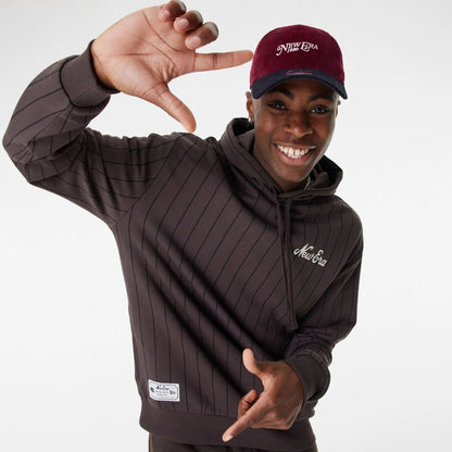 The Male model is wearing New Era Heritage Pinstripe Brown Oversized Hoodie 2