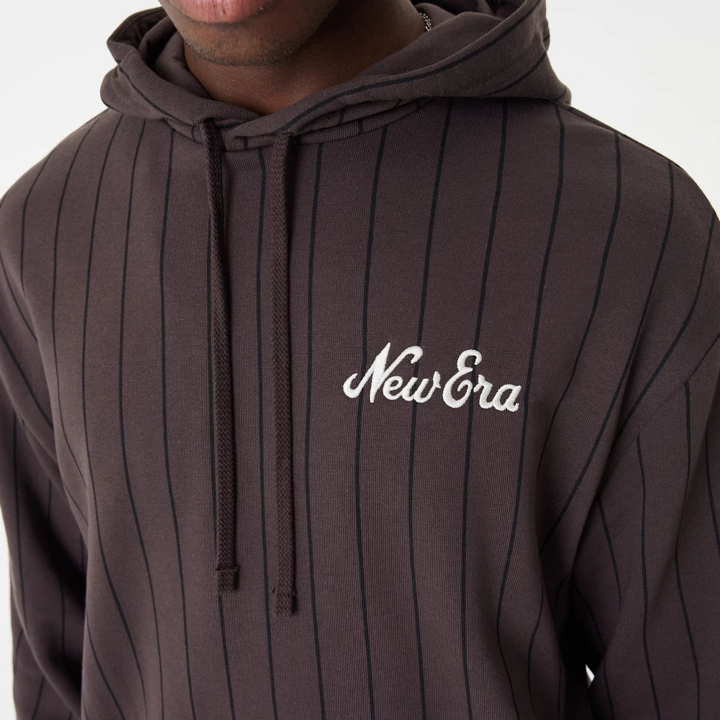 The Male model is wearing New Era Heritage Pinstripe Brown Oversized Hoodie 6