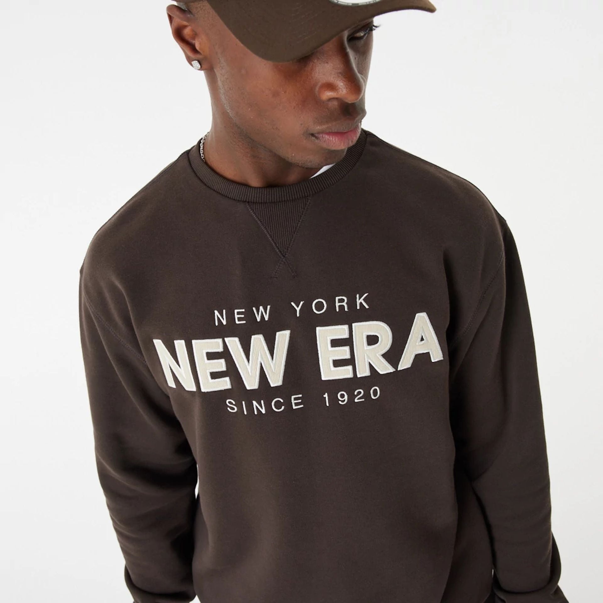 The Male model is wearing New Era Heritage Brown Crew Neck Sweatshirt 1