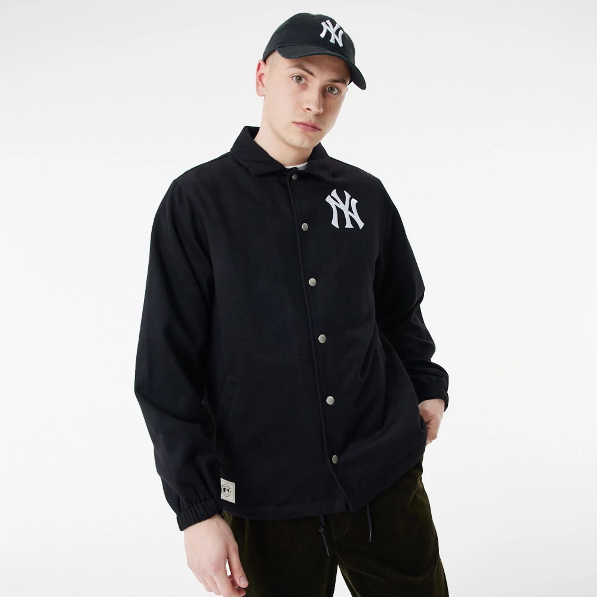 The Male model is wearing New York Yankees MLB Black Coaches Jacket 2