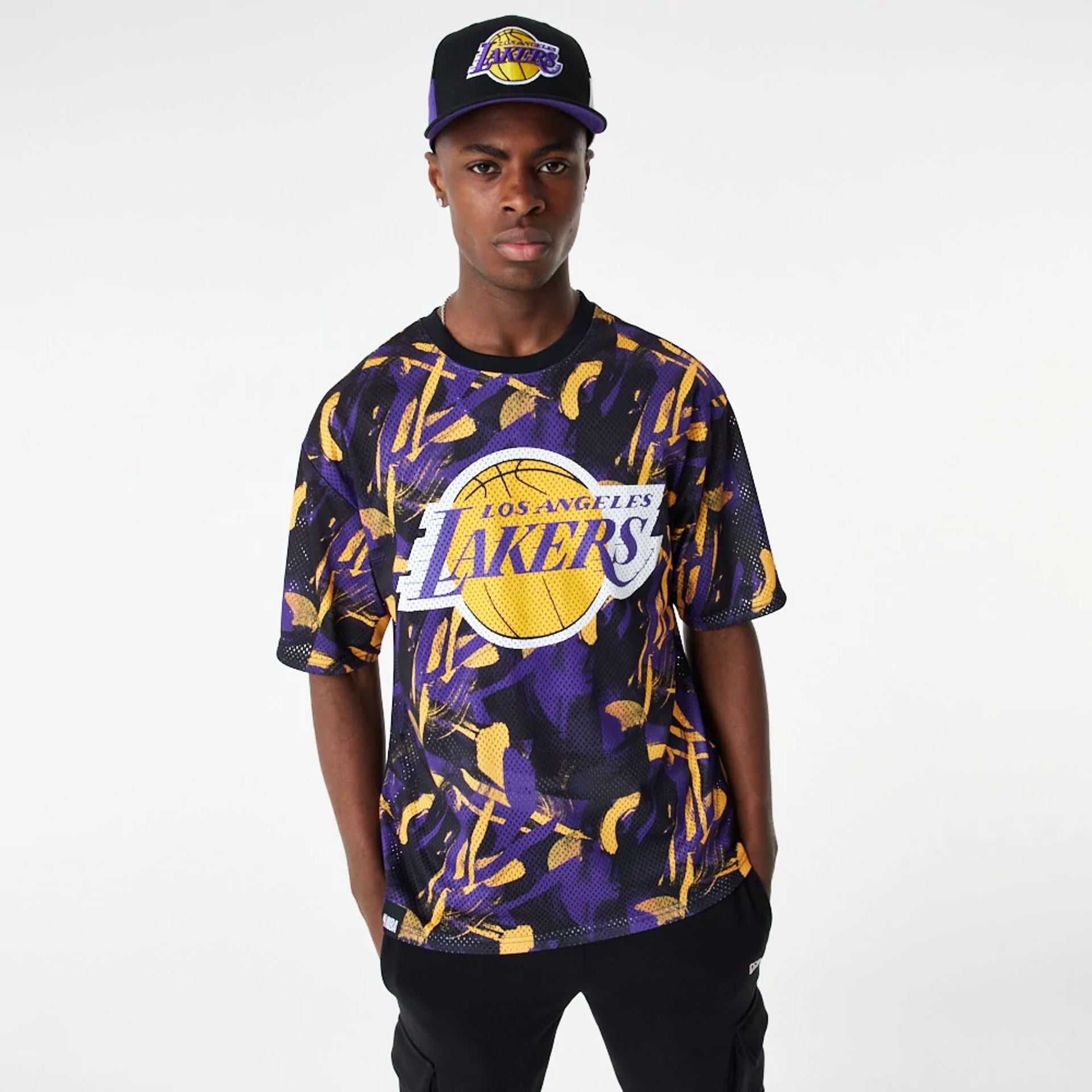 The Male model is wearing LA Lakers NBA All Over Print Mesh Purple Oversized T-Shirt 1