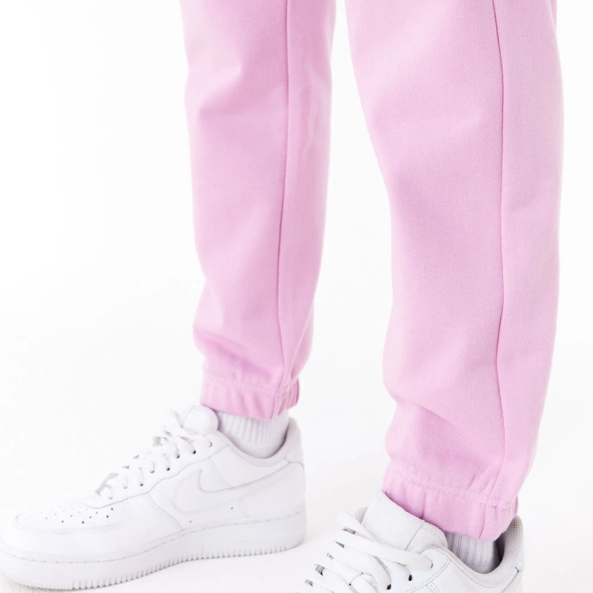 The Female model is wearing New Era Womens Arch Wordmark Pink Joggers 4