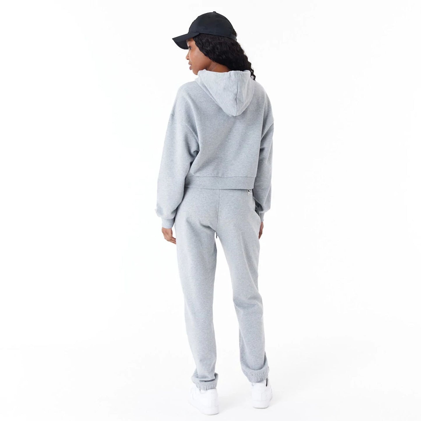 The Female model is wearing New Era Womens Arch Wordmark Grey Crop Pullover Hoodie 2