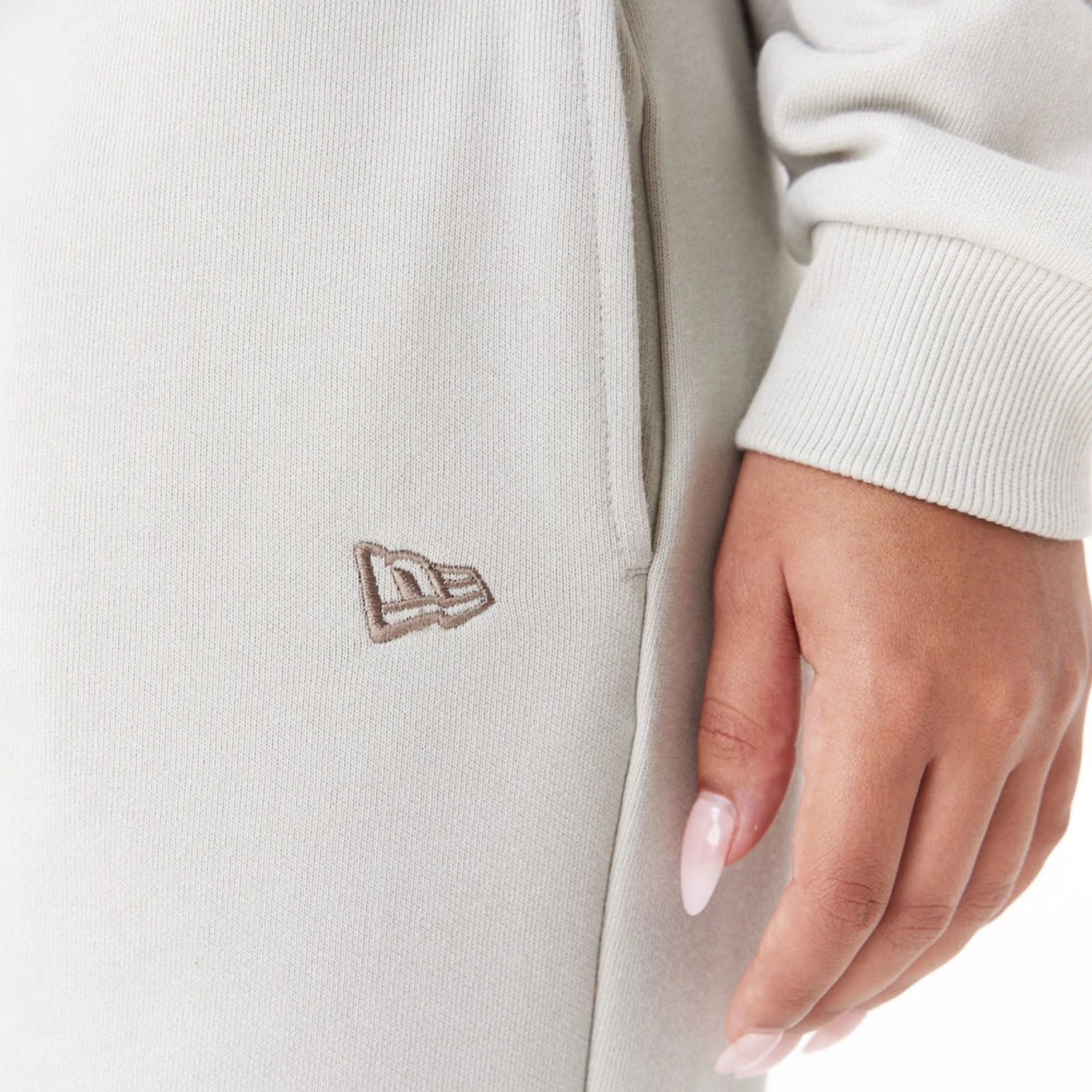 The Female model is wearing New Era Arch Wordmark Stone Womens Joggers 9