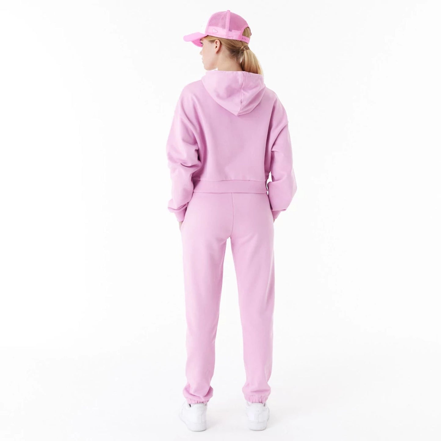 The Female model is wearing New Era Womens Arch Wordmark Pink Crop Pullover Hoodie 2