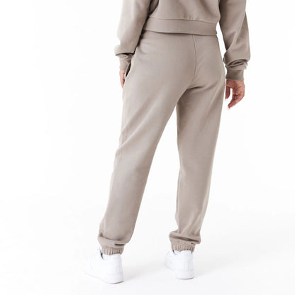 The Female model is wearing New Era Womens Arch Wordmark Brown Joggers 6