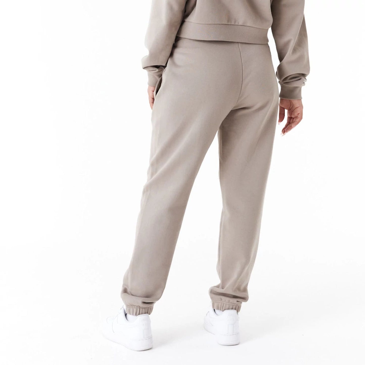 The Female model is wearing New Era Womens Arch Wordmark Brown Joggers 6