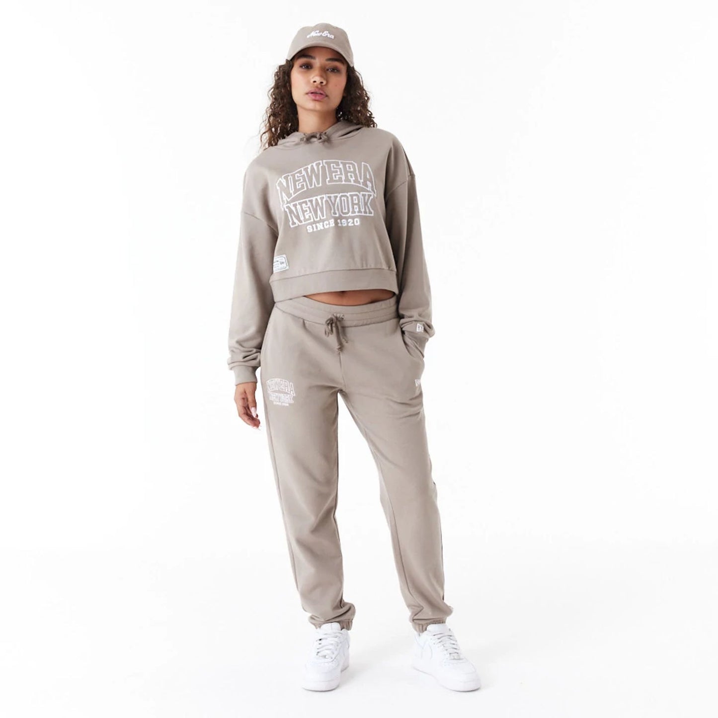 The Female model is wearing New Era Womens Arch Wordmark Brown Joggers 2