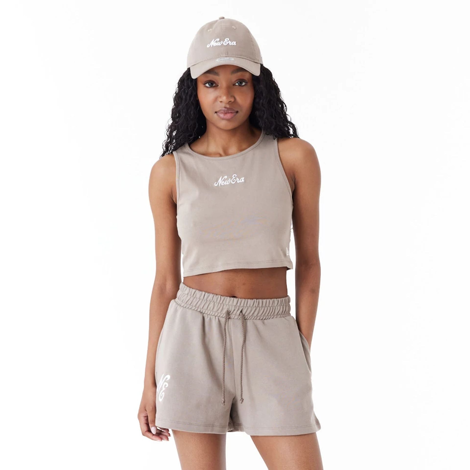 The Female model is wearing New Era Womens Brown Crop Tank Top 1