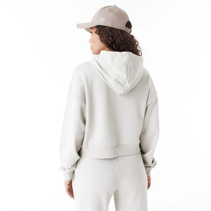 The Female model is wearing New Era Arch Wordmark Stone Womens Crop Pullover Hoodie 5