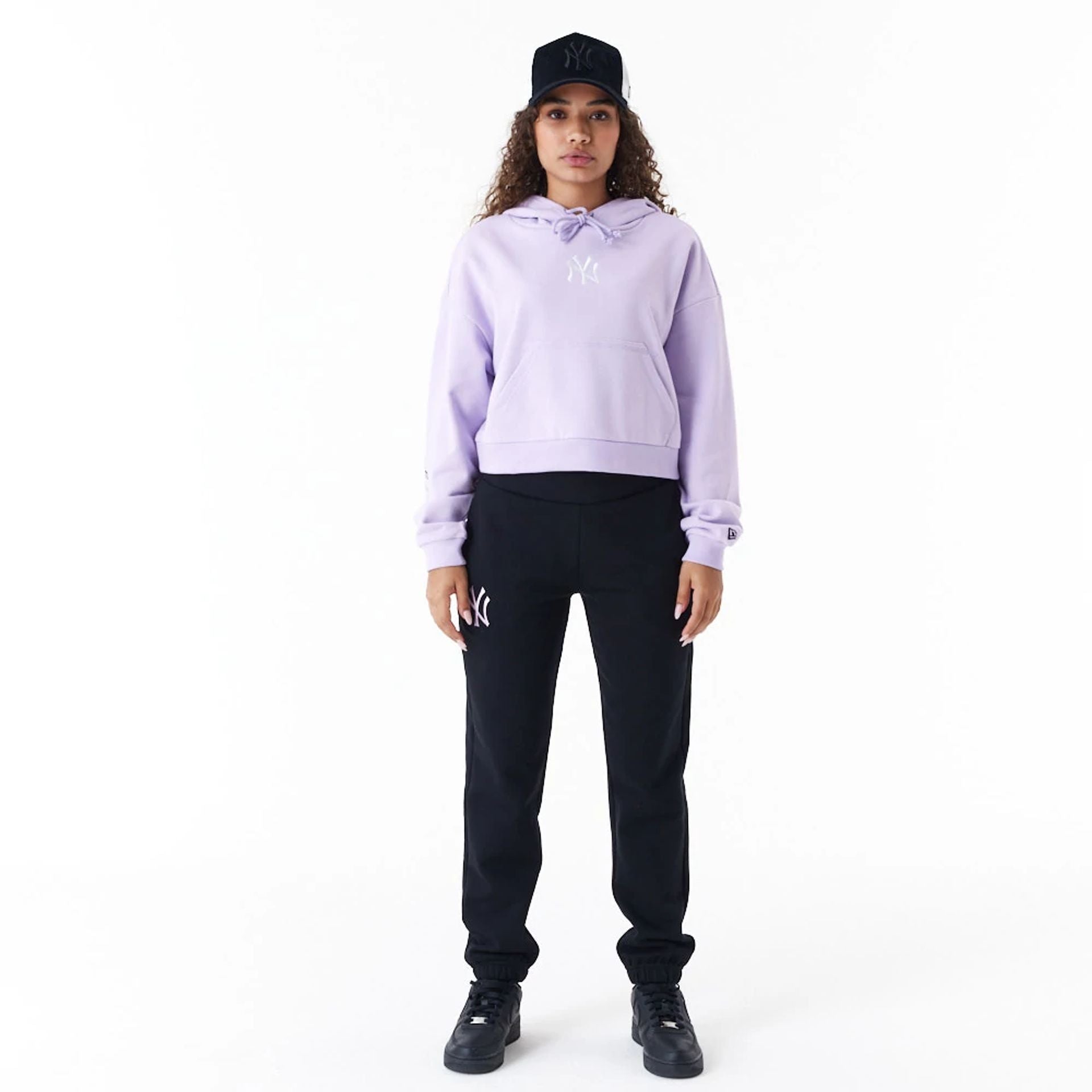 The Female model is wearing New York Yankees MLB Lifestyle Purple Womens Crop Pullover Hoodie 5