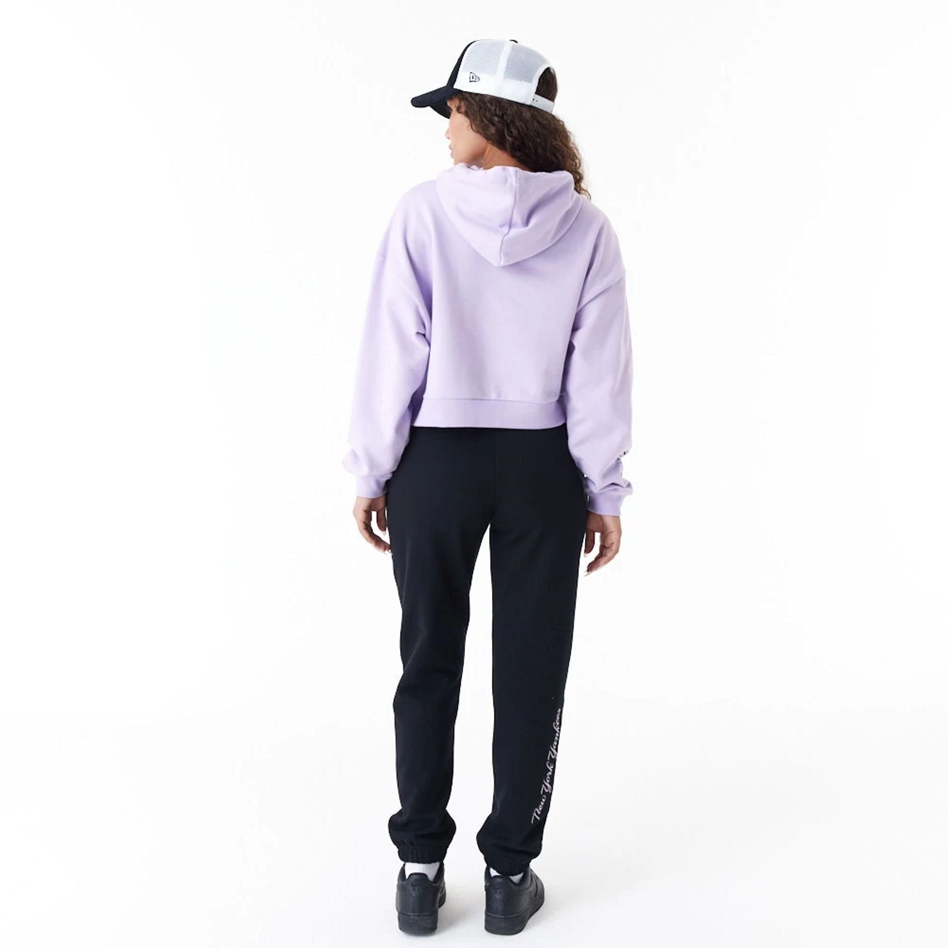 The Female model is wearing New York Yankees MLB Lifestyle Purple Womens Crop Pullover Hoodie 3