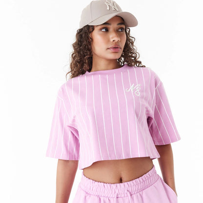 The Female model is wearing New Era Pinstripe Pink Womens Crop T-Shirt 2