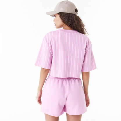 The Female model is wearing New Era Pinstripe Pink Womens Crop T-Shirt 6