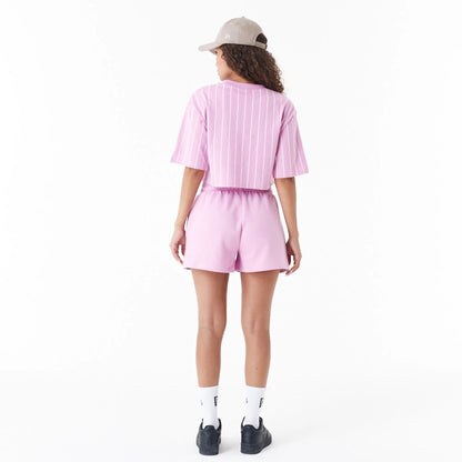 The Female model is wearing New Era Pinstripe Pink Womens Crop T-Shirt 4