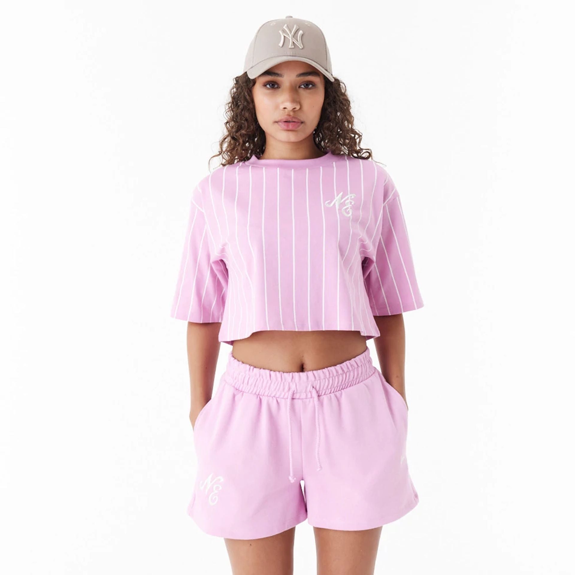 The Female model is wearing New Era Pinstripe Pink Womens Crop T-Shirt 1