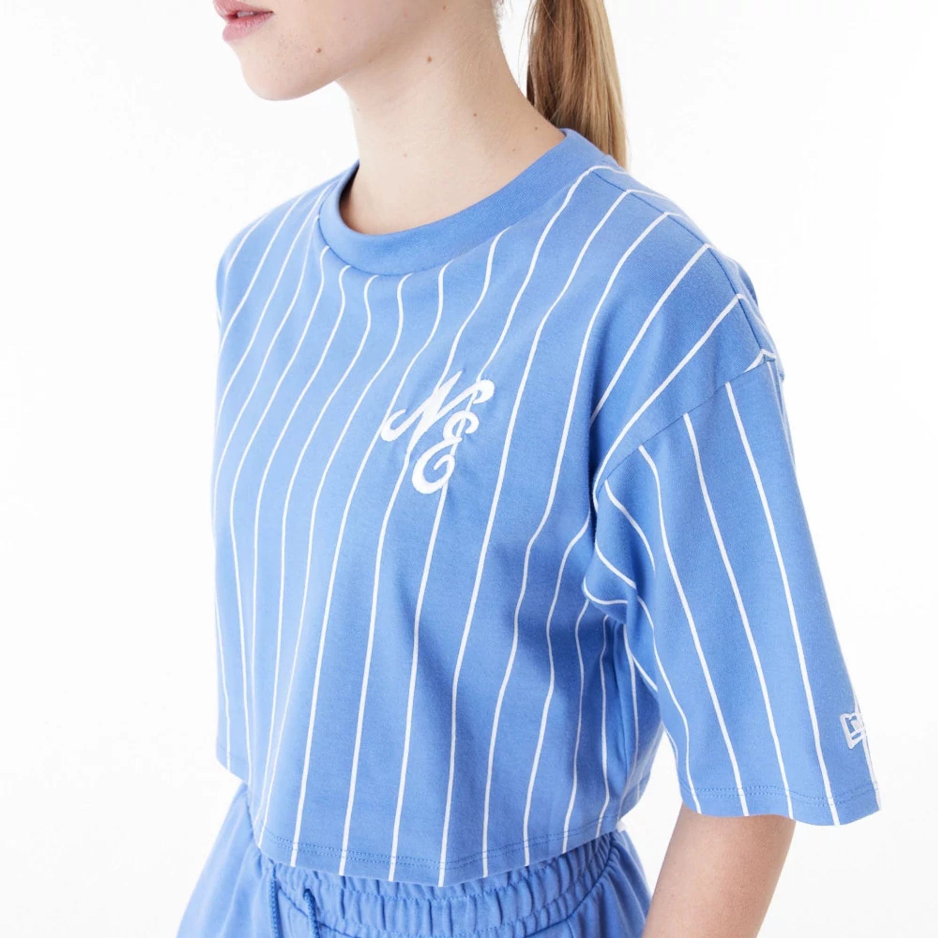 The Female model is wearing New Era Pinstripe Blue Womens Crop T-Shirt 7