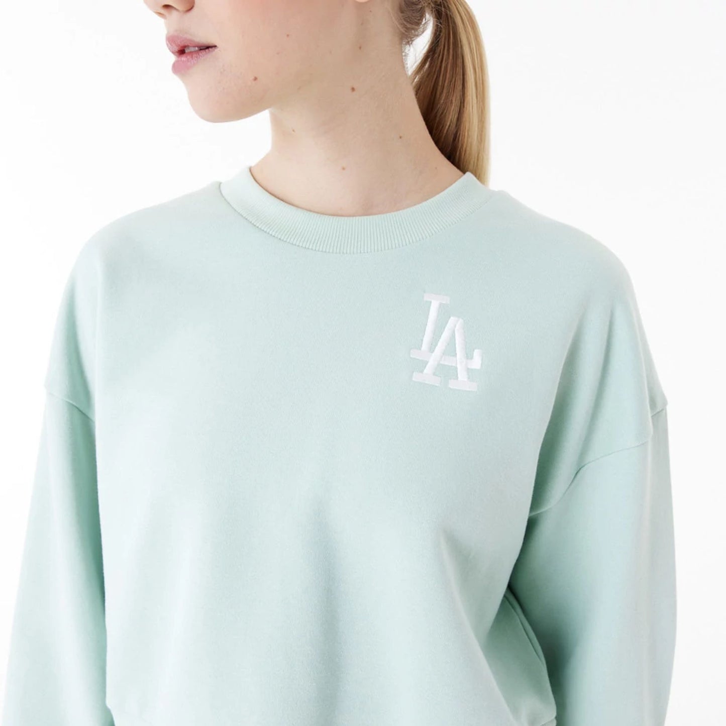 The Female model is wearing LA Dodgers MLB Lifestyle Mint Womens Crop Crew Neck Sweatshirt 7