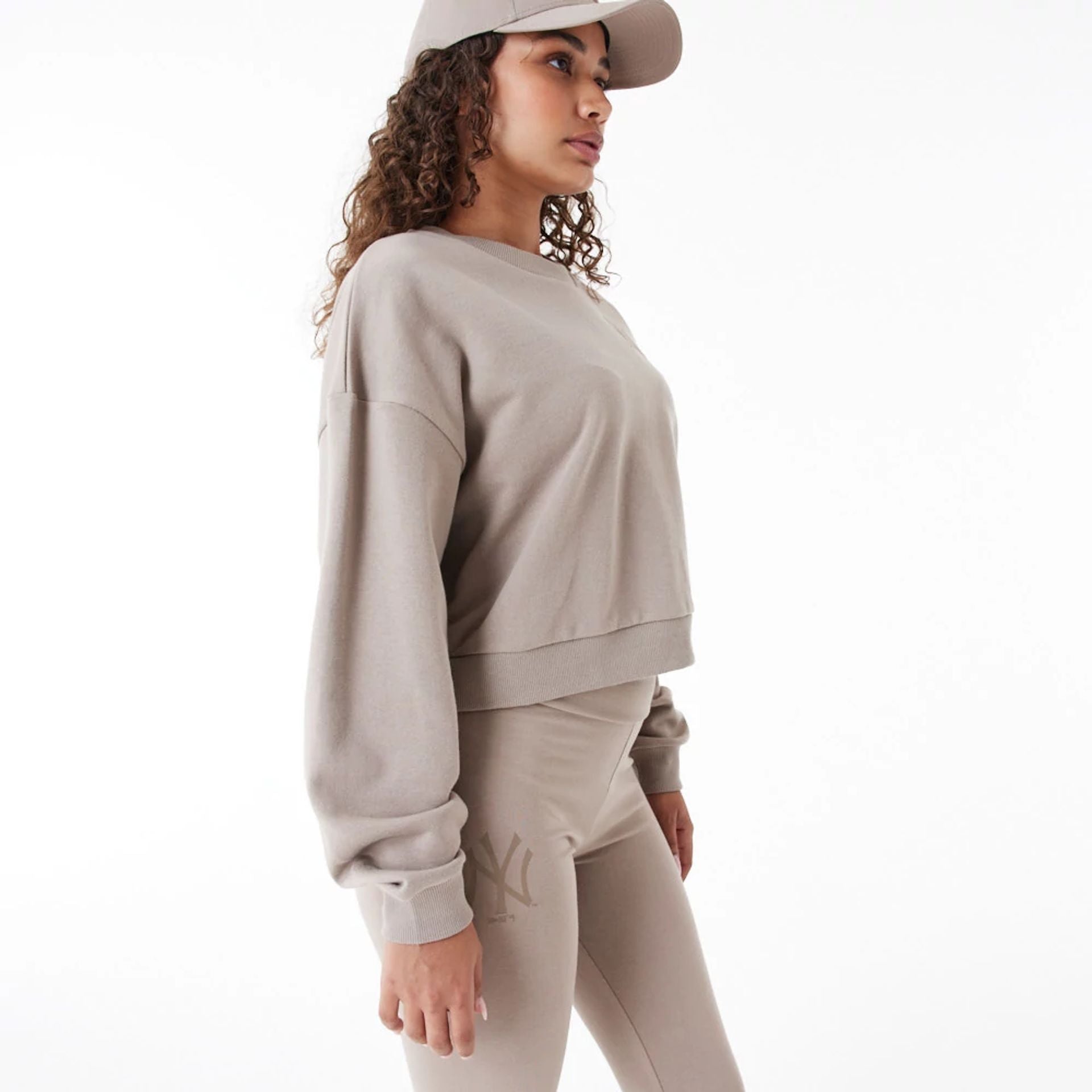 The Female model is wearing New York Yankees Womens MLB Lifestyle Brown Crop Crew Neck Sweatshirt 9