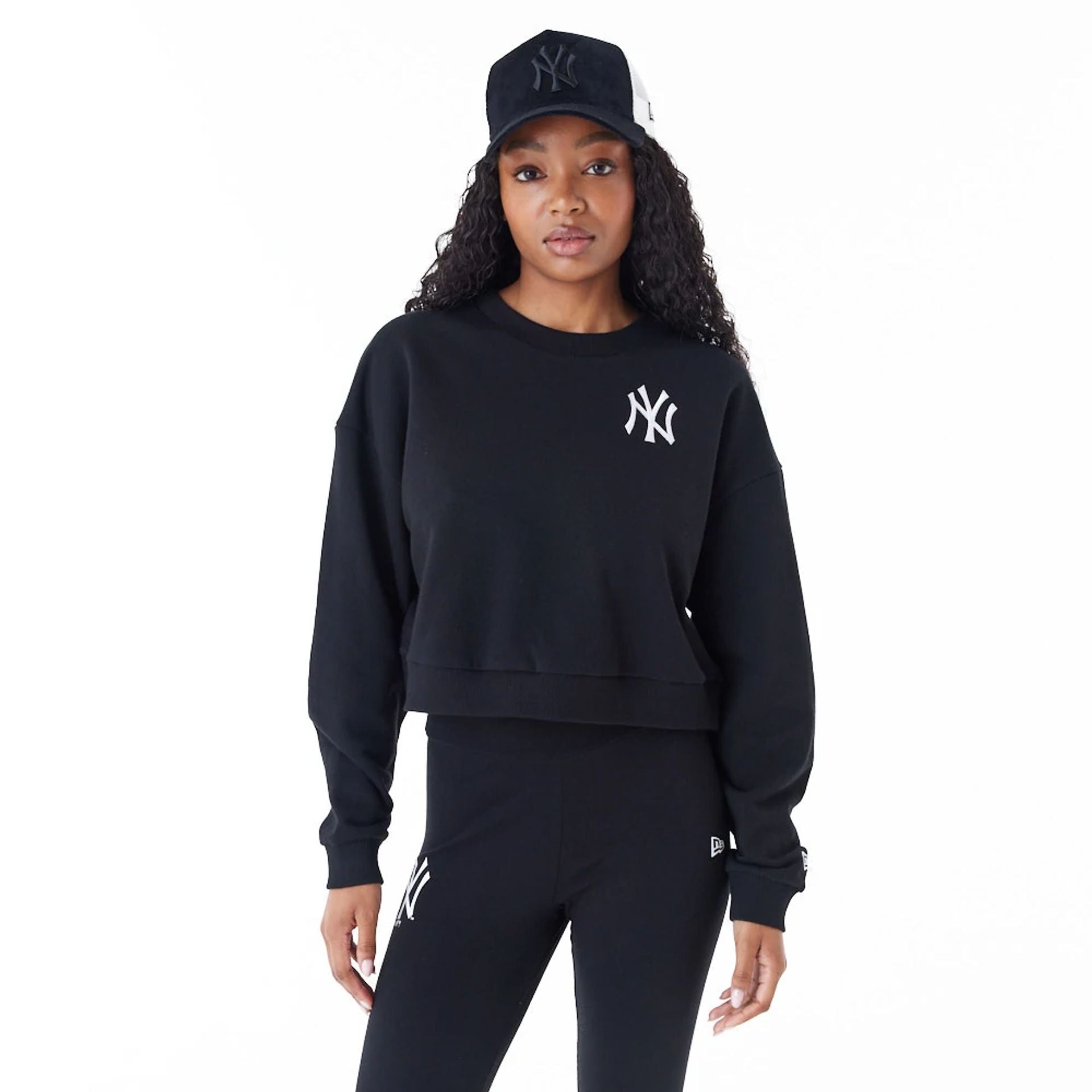 The Female model is wearing New York Yankees Womens MLB Lifestyle Black Crop Crew Neck Sweatshirt 1