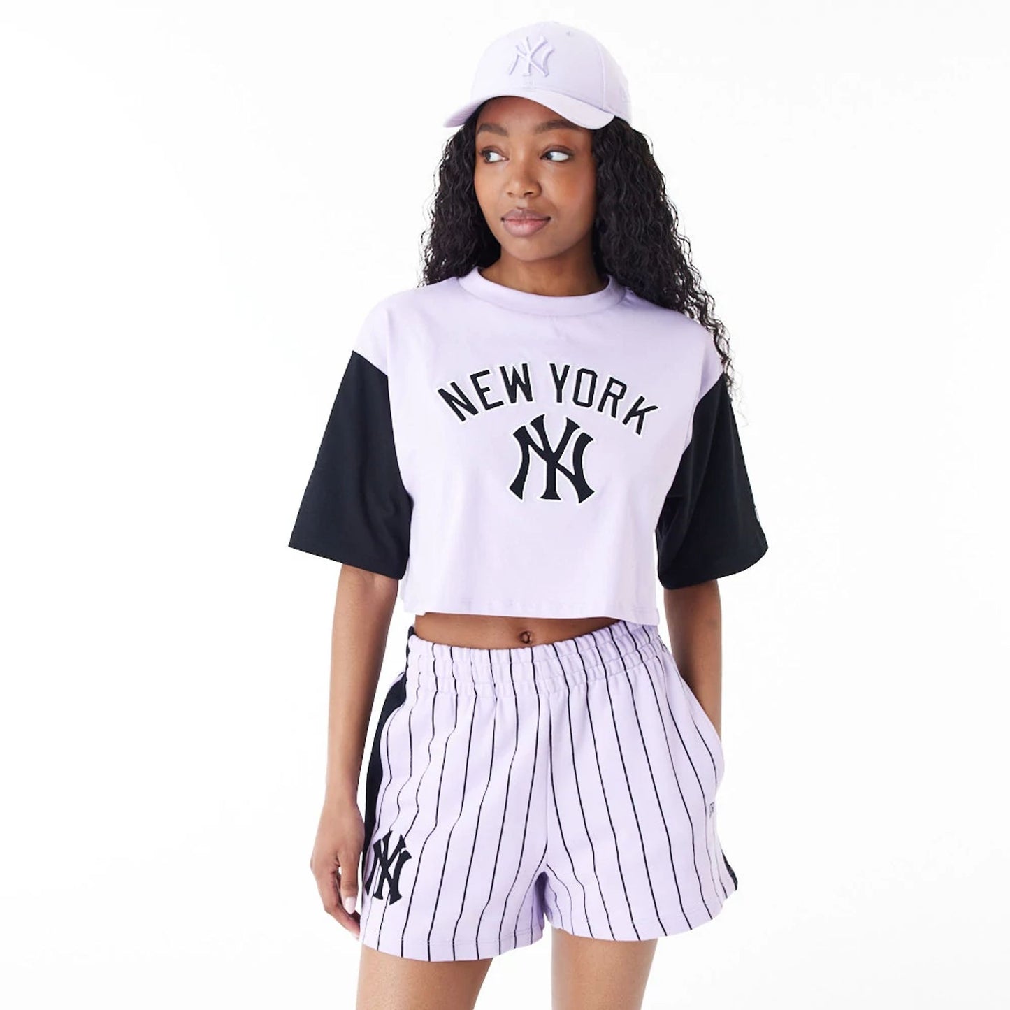 The Female model is wearing New York Yankees MLB Lifestyle Purple Womens Crop T-Shirt 1