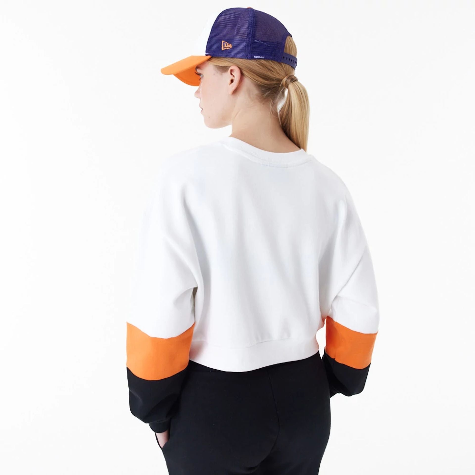 The Female model is wearing Phoenix Suns Womens NBA Colour Block White Crop Crew Neck Sweatshirt 3