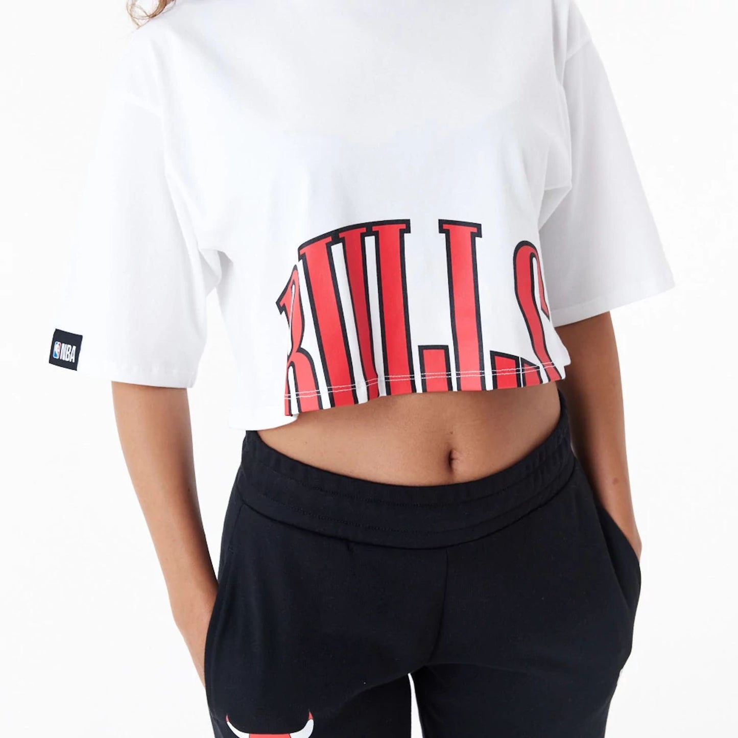 The Female model is wearing Chicago Bulls Womens NBA Team Wordmark White Crop T-Shirt 9