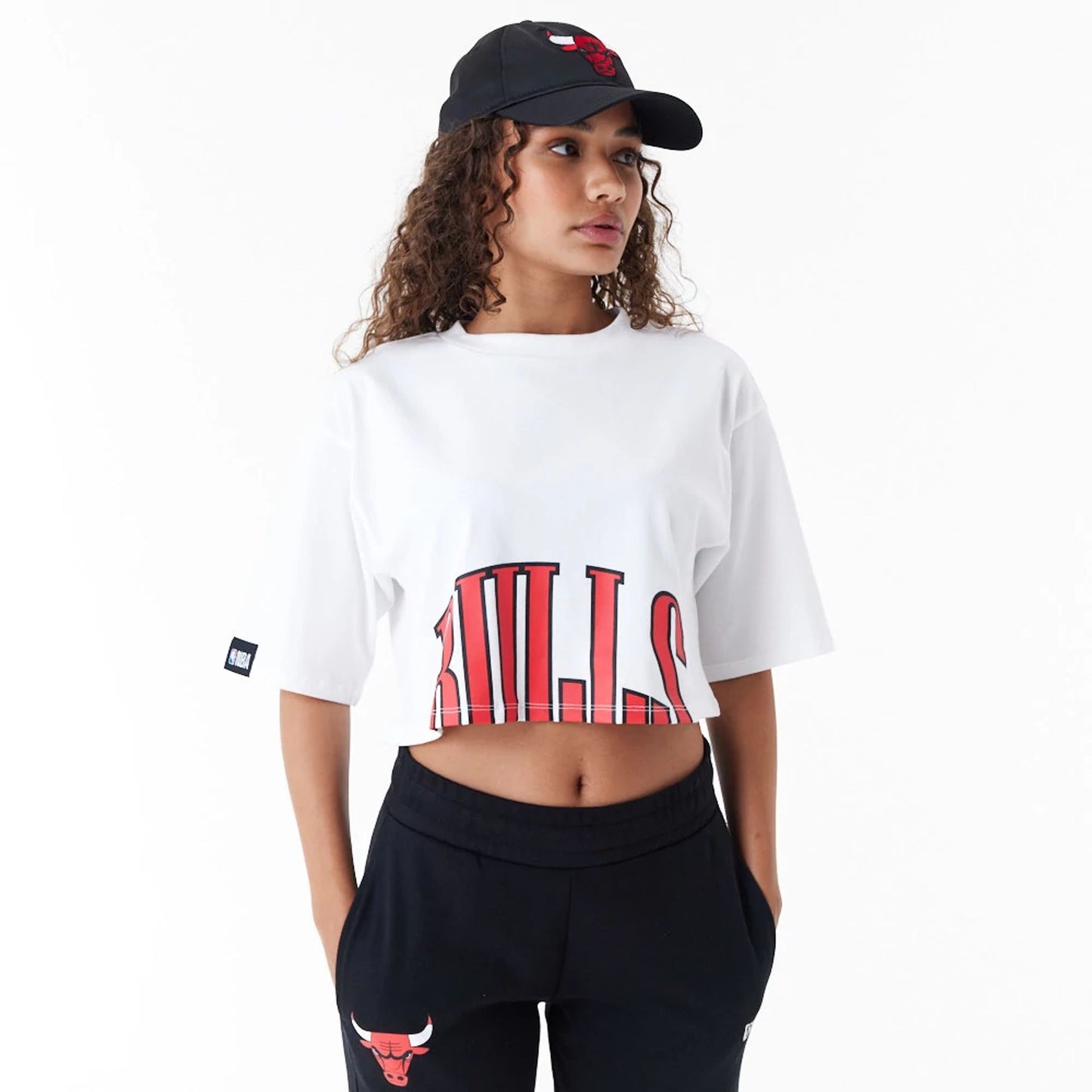 The Female model is wearing Chicago Bulls Womens NBA Team Wordmark White Crop T-Shirt 5