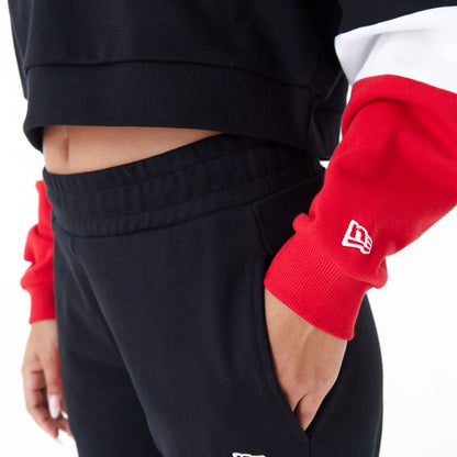 The Female model is wearing Chicago Bulls Womens NBA Colour Block Black Crop Crew Neck Sweatshirt 5