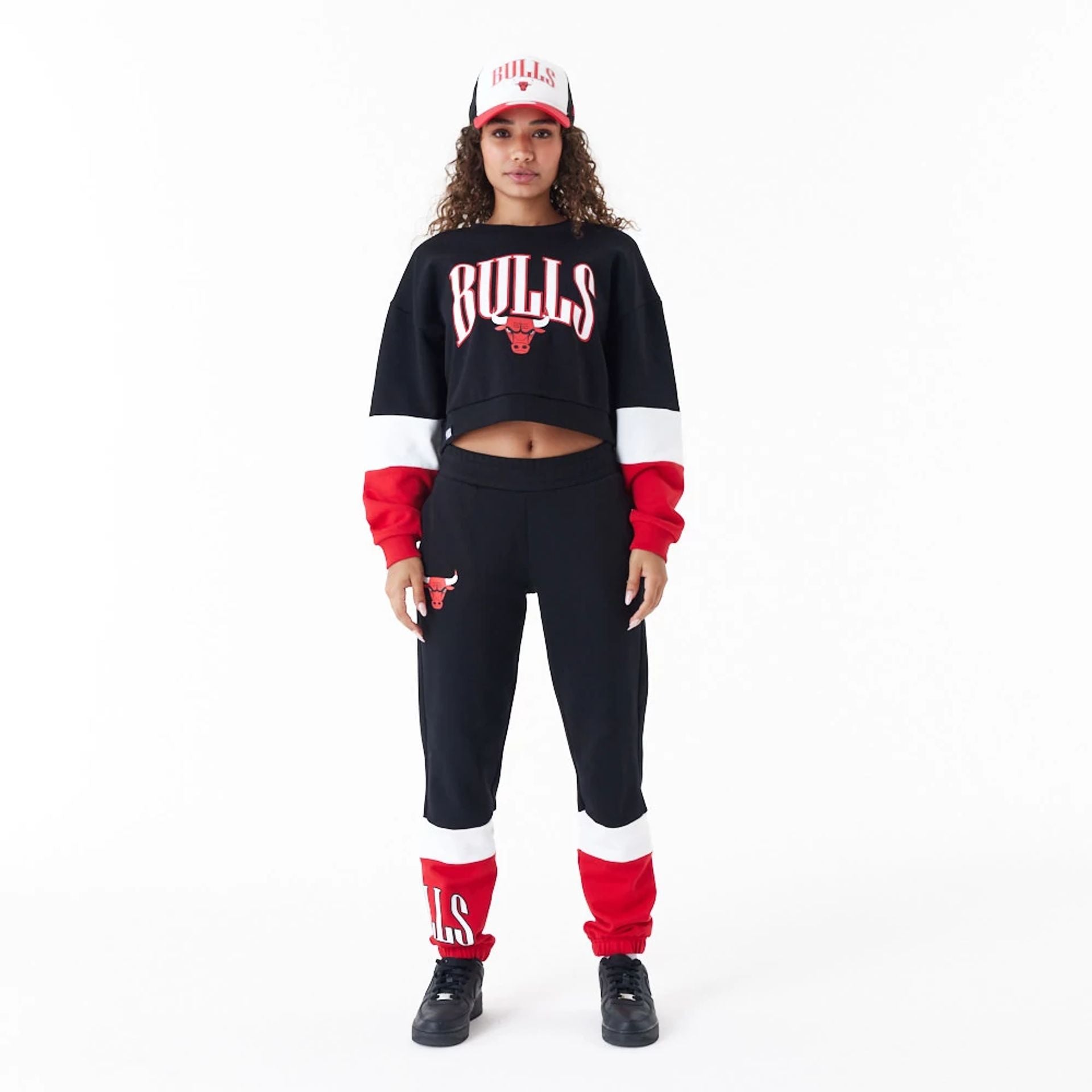 The Female model is wearing Chicago Bulls Womens NBA Colour Block Black Crop Crew Neck Sweatshirt 6