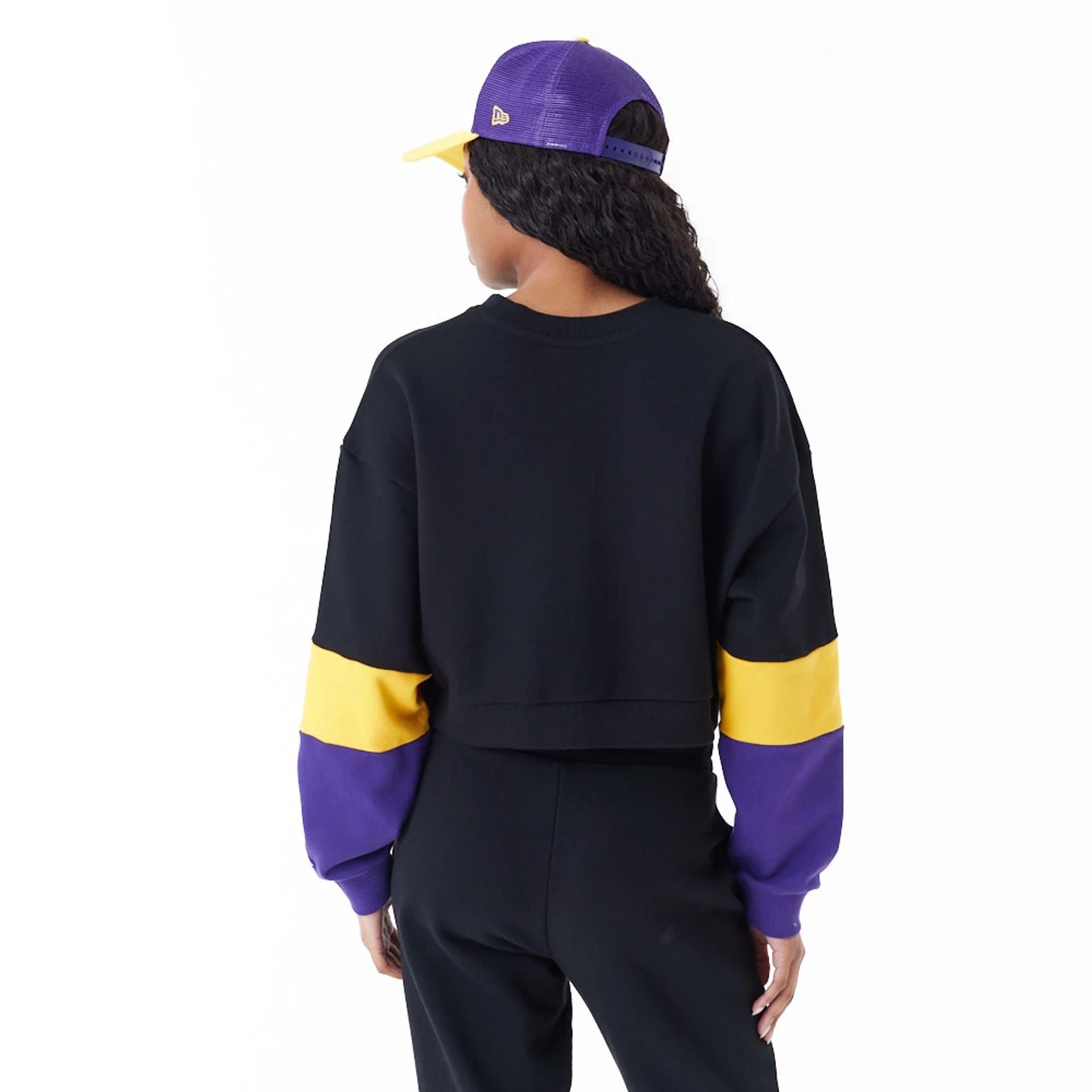 The Female model is wearing LA Lakers Womens NBA Colour Block Black Crop Crew Neck Sweatshirt 4