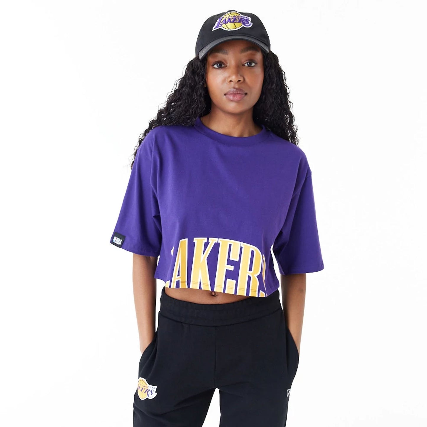 The Female model is wearing LA Lakers Womens NBA Team Wordmark Purple Crop T-Shirt 1