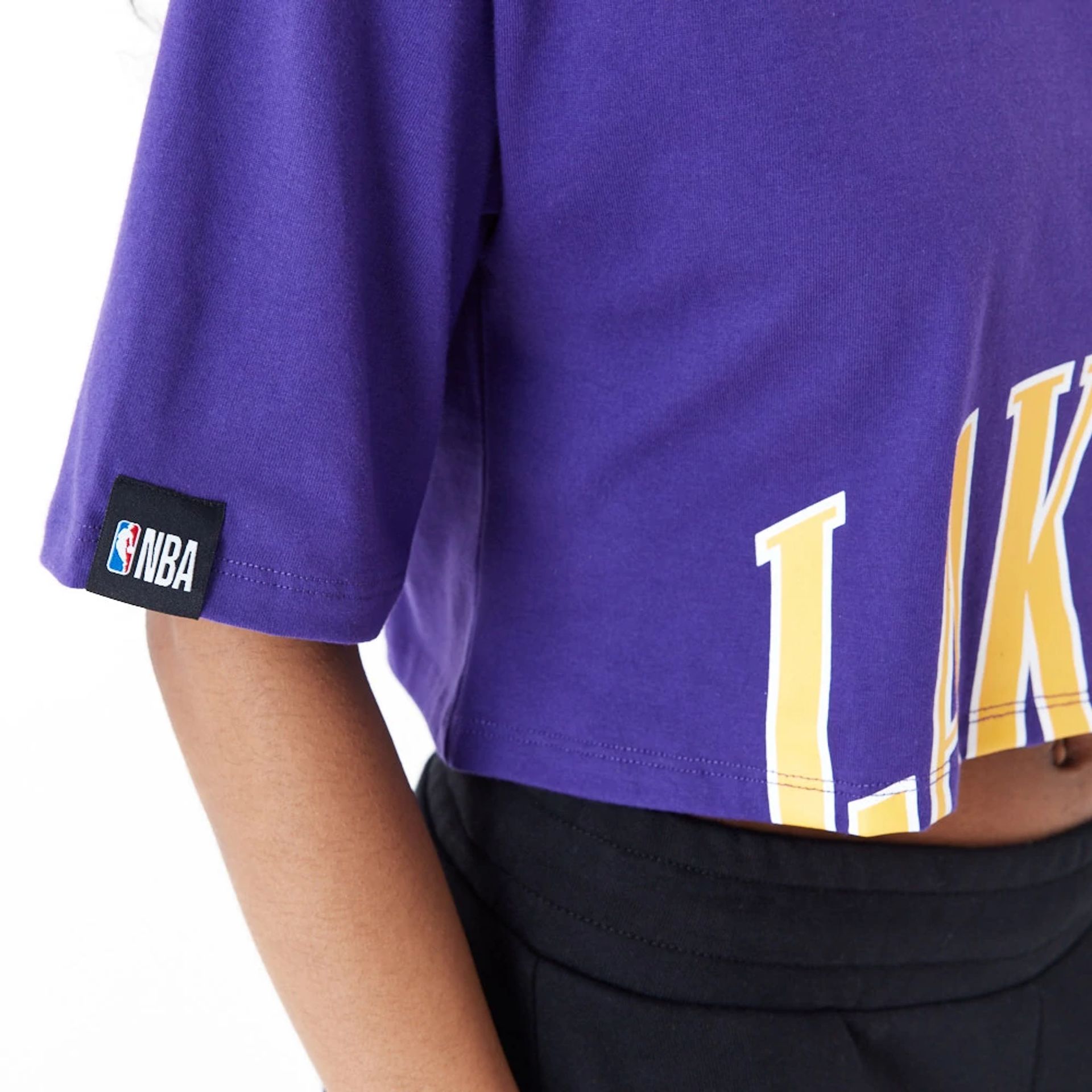 The Female model is wearing LA Lakers Womens NBA Team Wordmark Purple Crop T-Shirt 5